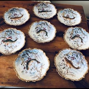 Eight antique Limoges plates with fish design